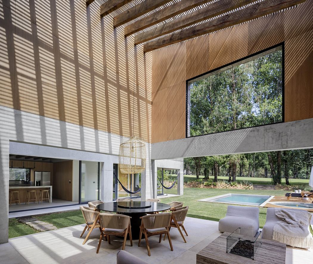 Modern living space with wooden slats, large window, and outdoor view.