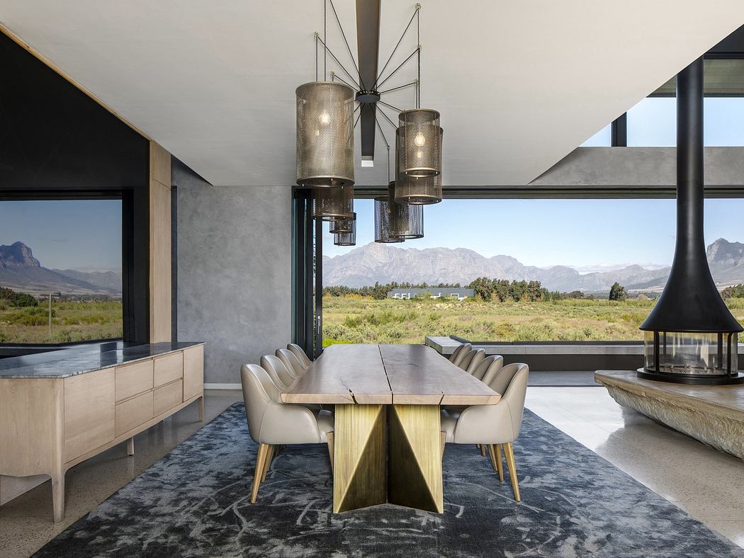 Modern dining room with artistic chandelier and mountain view.