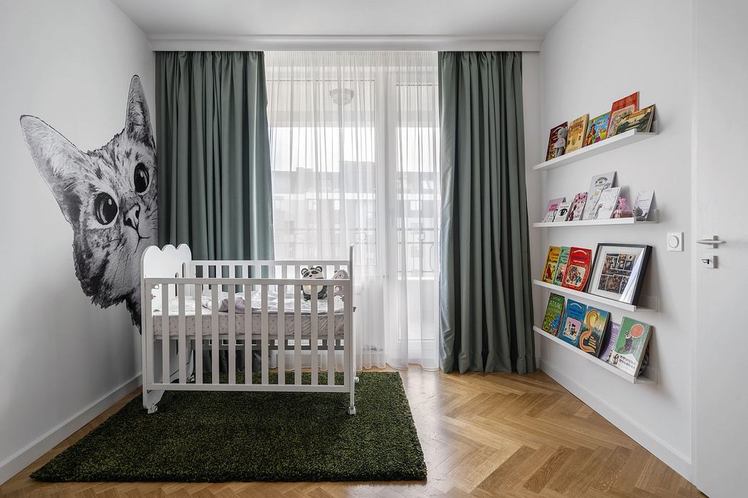 Modern nursery with a large cat wall mural, white crib, and bookshelves