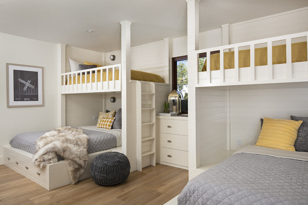 Modern bedroom with built-in bunk beds and neutral tones.