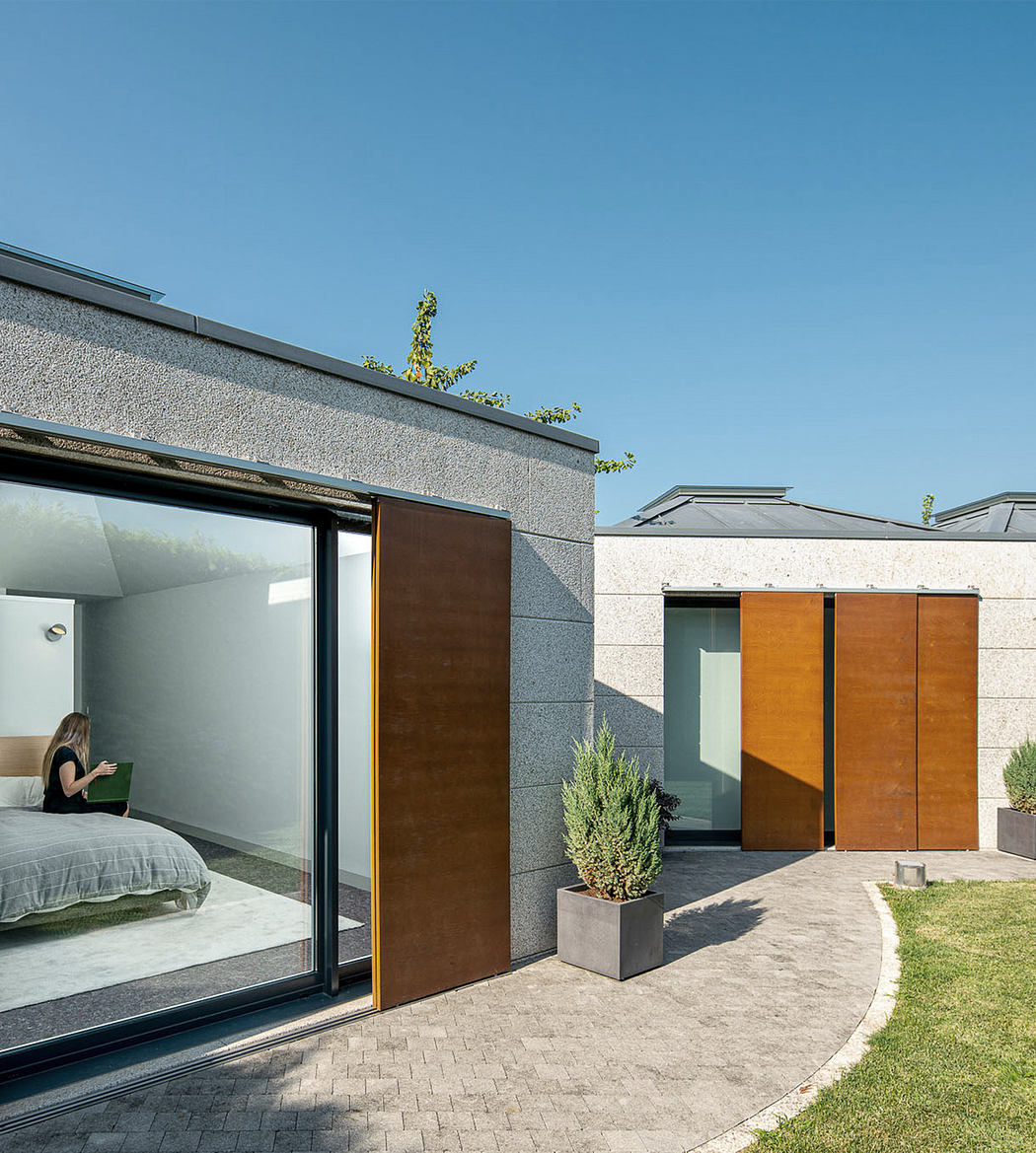 Modern house exterior with large windows and minimalist design.