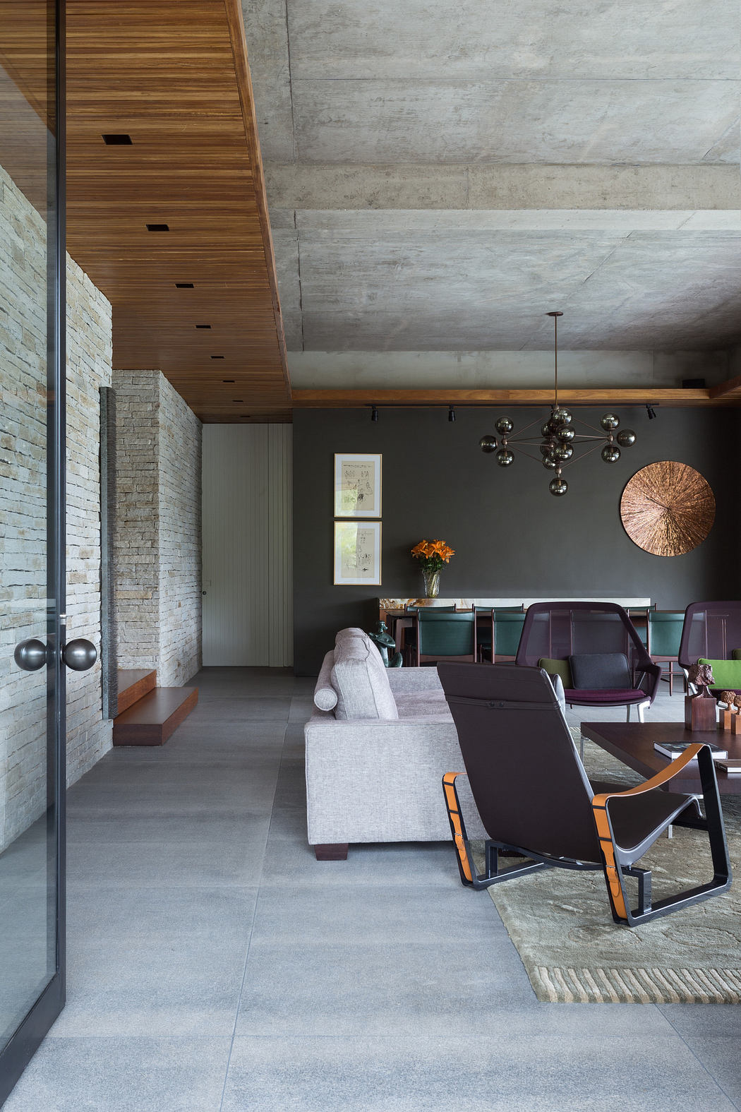 Modern living room with concrete ceiling, wooden accents, and stylish furniture.