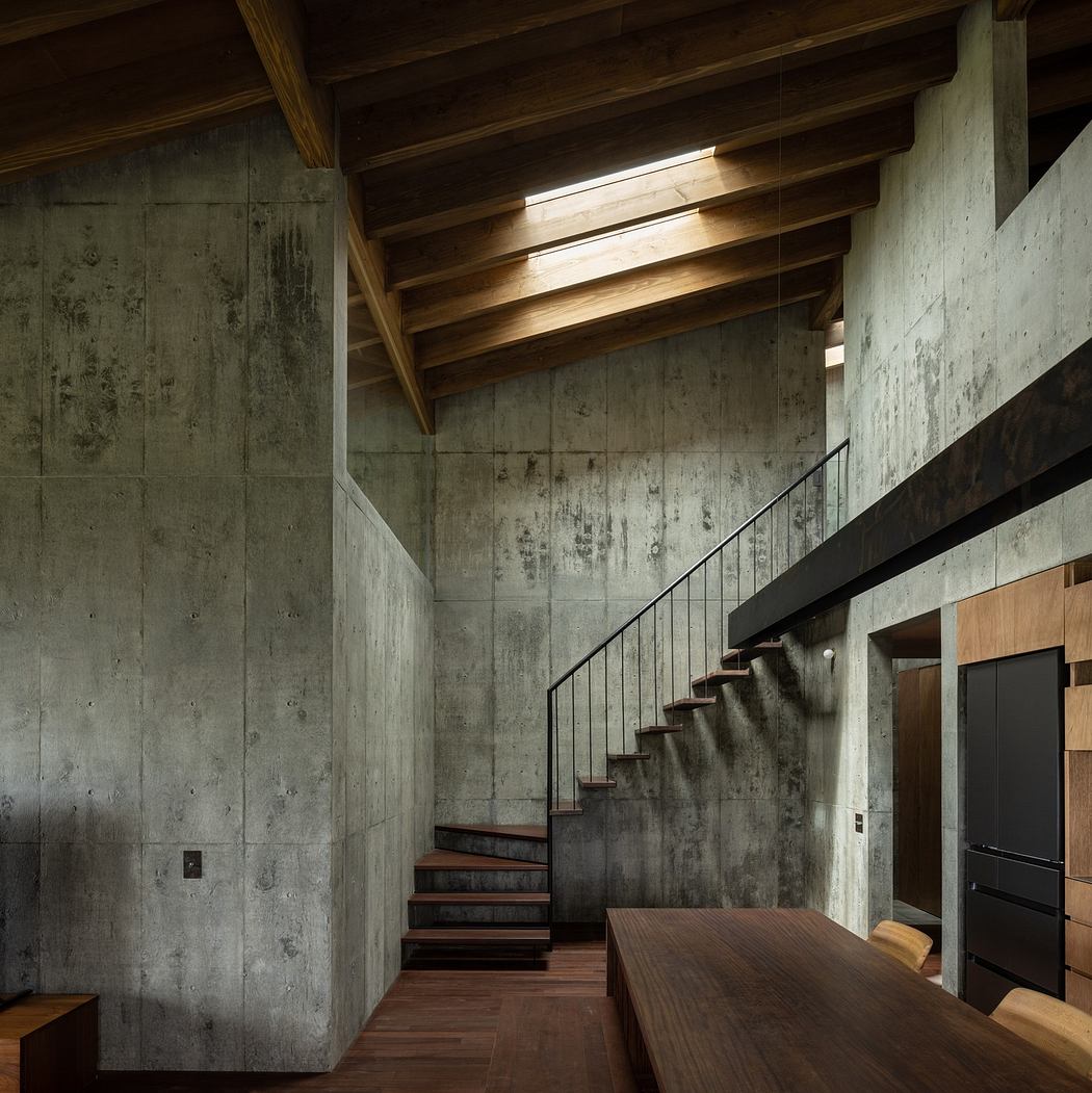 Modern interior with concrete walls, wooden ceiling, and staircase.