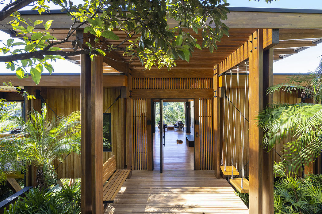 Modern wooden pavilion with lush greenery surrounds.