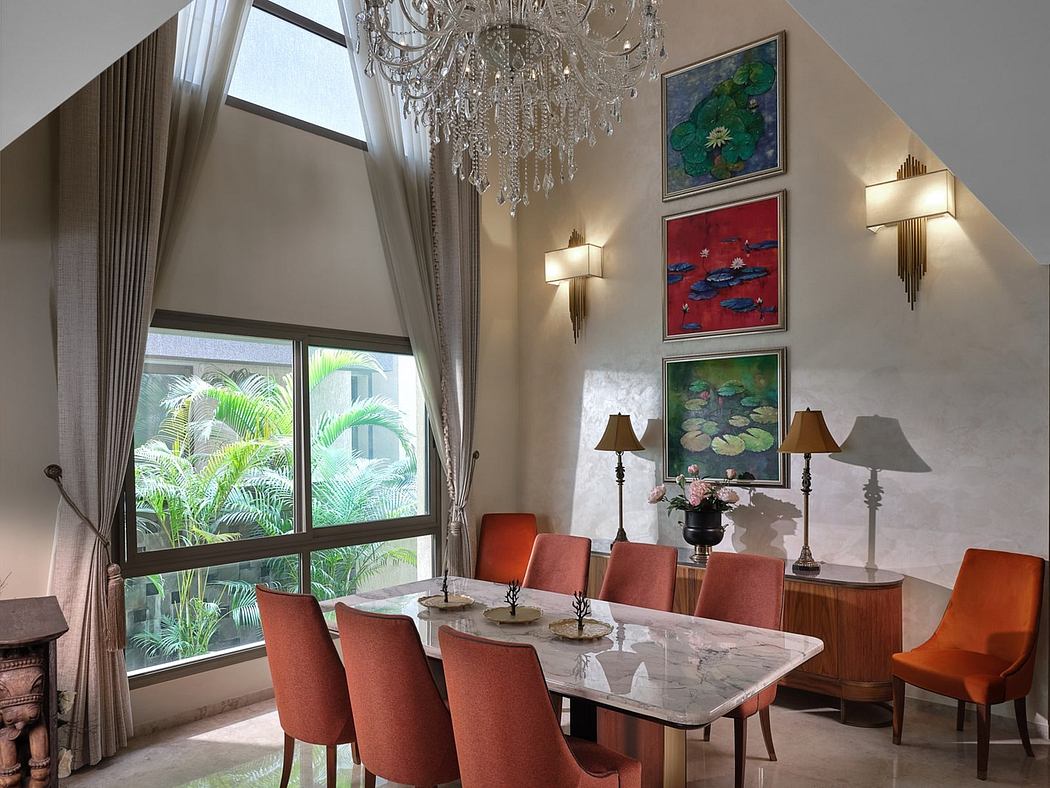 Elegant dining room with high ceilings, chandelier, and modern art.