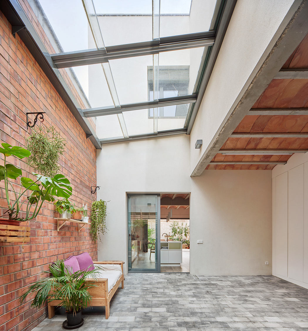Interior patio with glass roof, brick walls, and wooden accents.