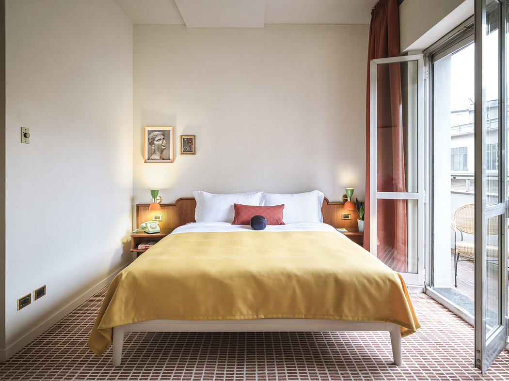 Cozy bedroom with a neatly made bed, open balcony door, and warm lighting