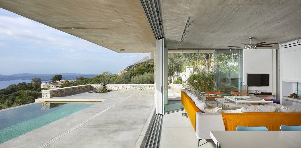 Modern open-plan living space with seamless indoor-outdoor transition and infinity pool.