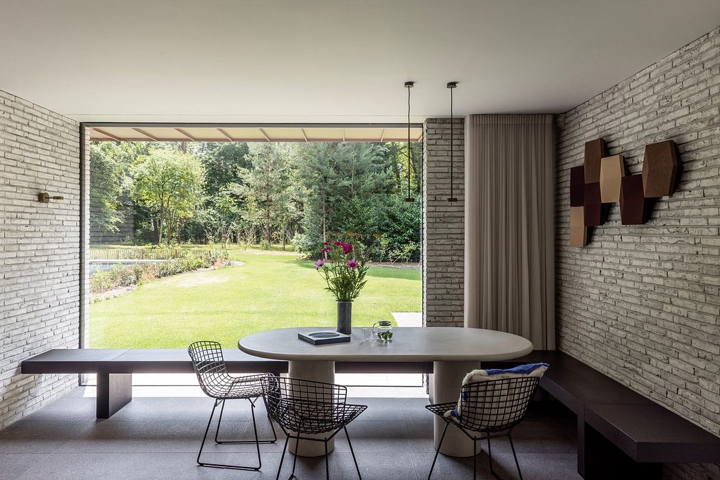 Modern room with large window overlooking a garden.