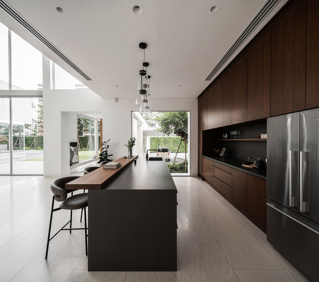 Modern kitchen interior with dark wood cabinets and island.