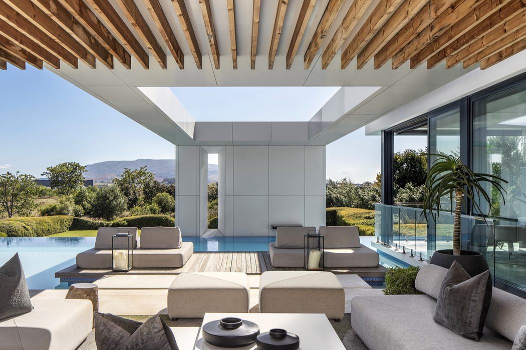 Modern patio with pool view, wooden ceiling, and minimalist furniture.