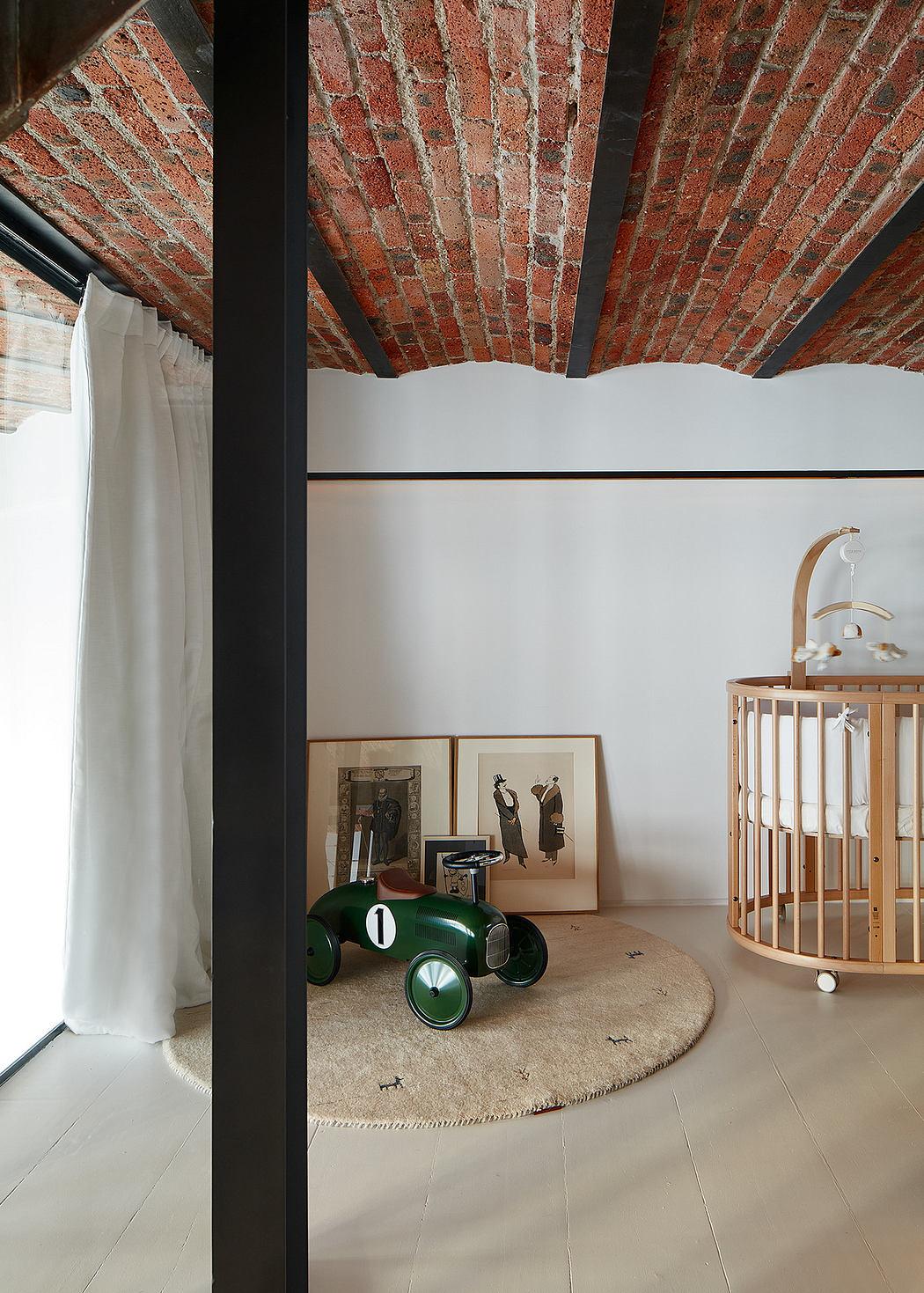 Modern room with exposed brick ceiling, vintage toys, and minimalistic decor.