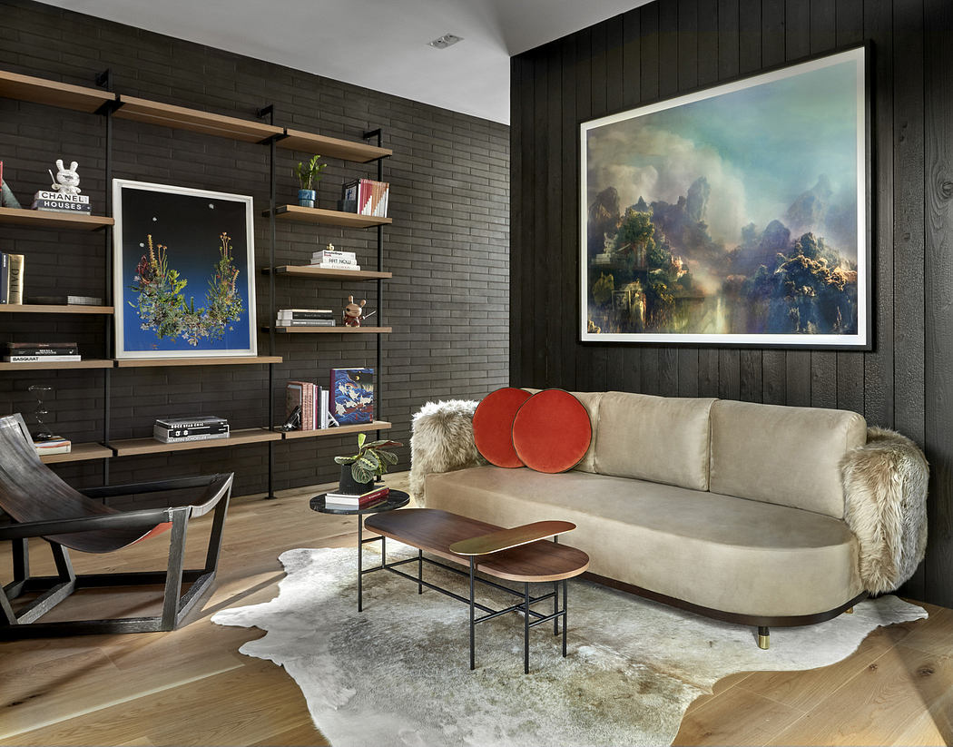 Modern living room with dark wood walls, plush sofa, and contemporary art.