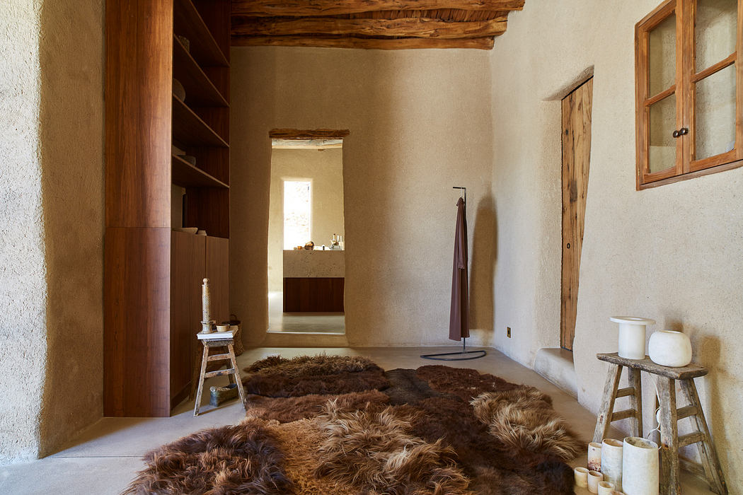 Rustic interior with wooden elements, fur rug, and minimal decor.
