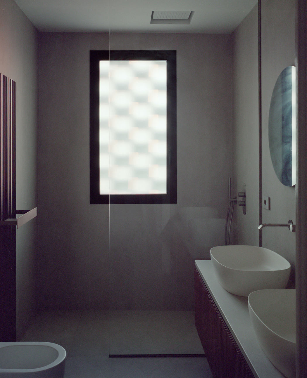 Modern bathroom with frosted window light and minimalistic design.