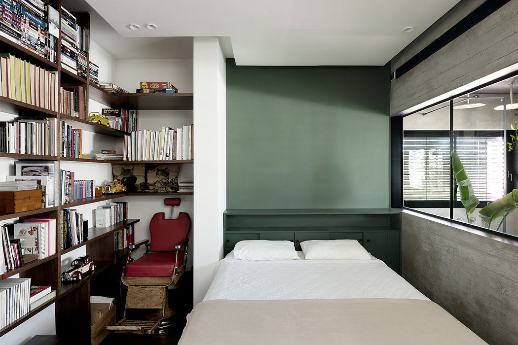 Modern bedroom with built-in bookshelves and a concrete accent wall.