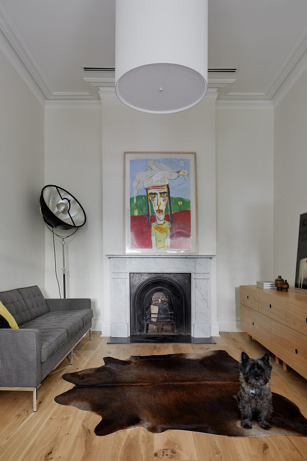 Elegant living room with a high ceiling, fireplace, modern art, and a