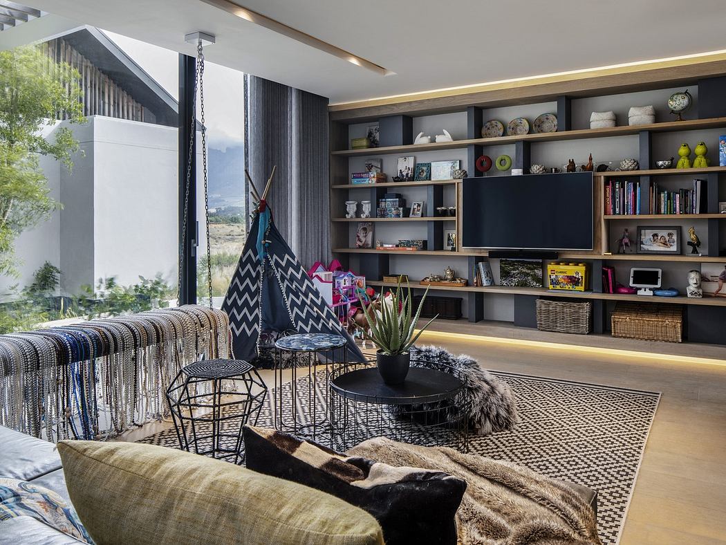 Modern living room with a large bookshelf, patterned rug, and cozy seating