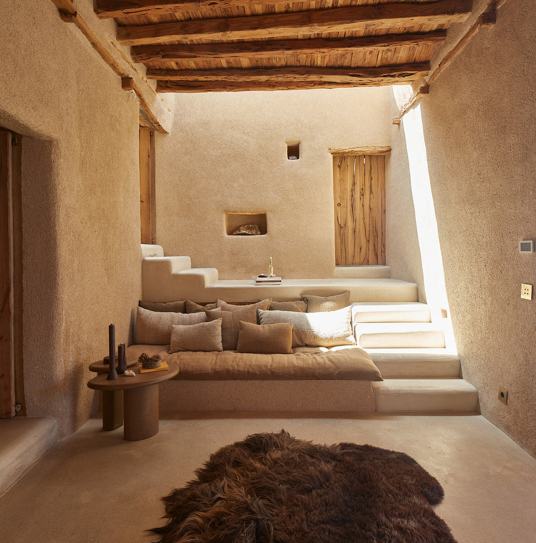 Rustic interior with adobe walls, wooden beams, cushioned steps,