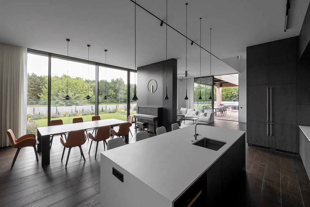 Modern kitchen and dining area with large windows and minimalist design.
