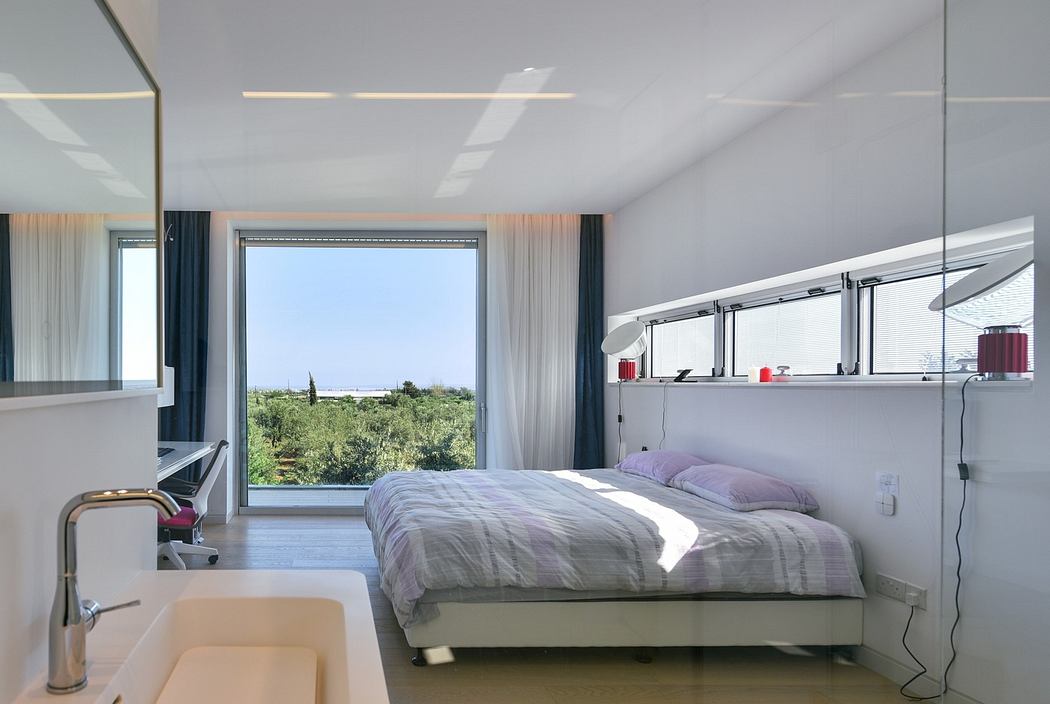 Modern bedroom with large window, minimalistic design, and neutral tones.