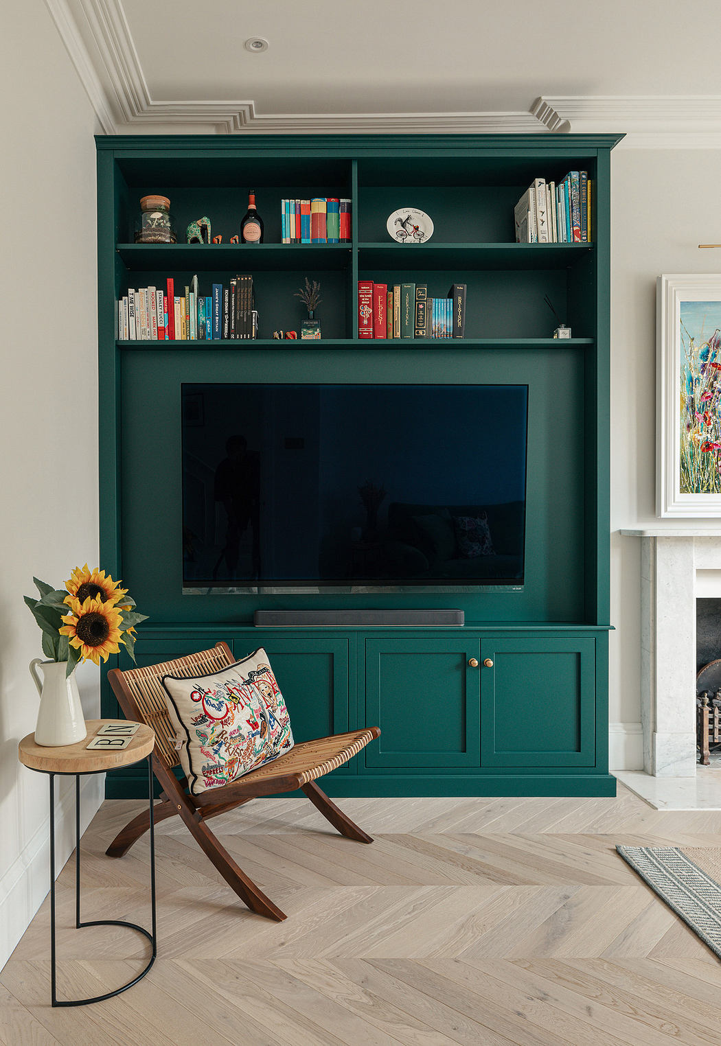 Elegant living room with a green built-in bookshelf, modern chair, and