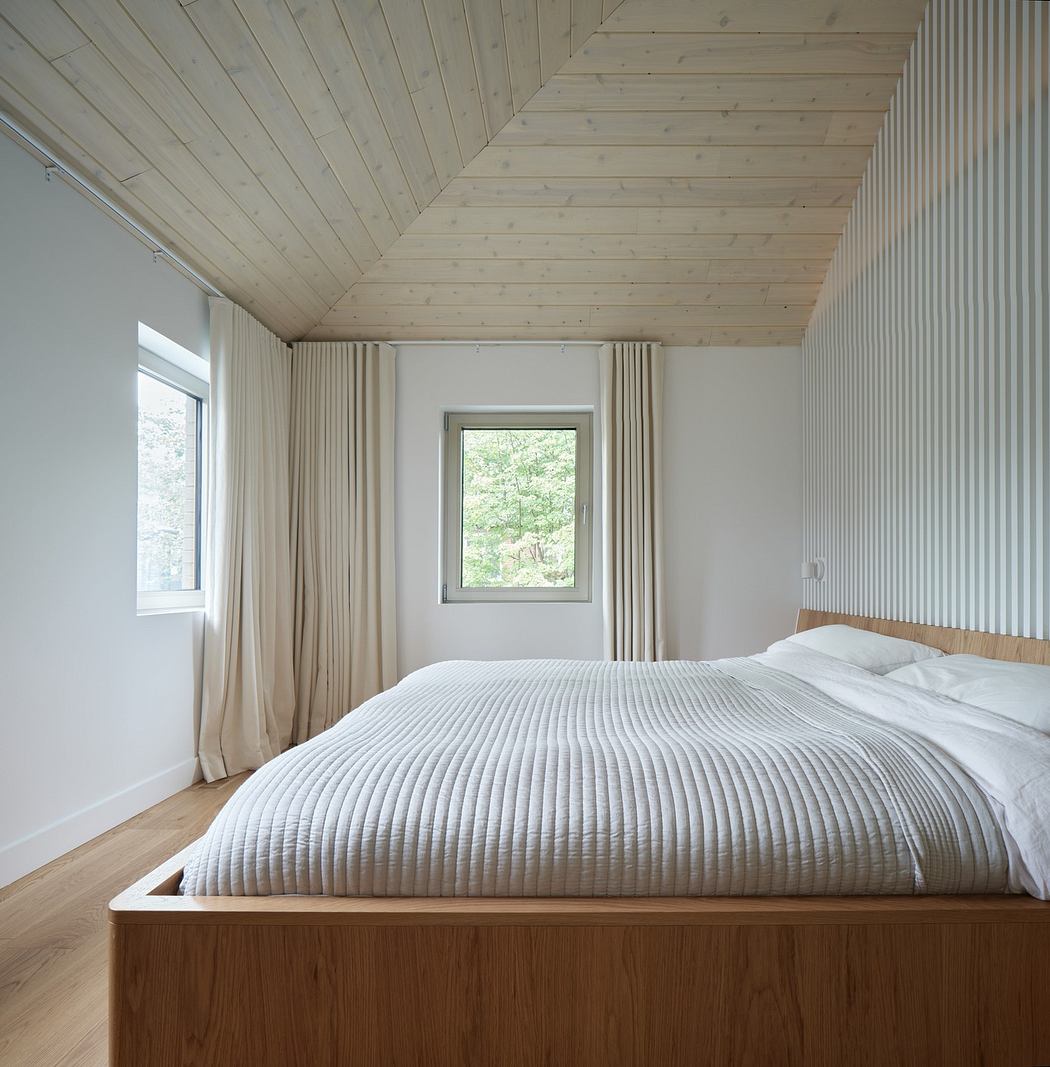 Minimalist bedroom with wooden bed, slatted walls, and inclined ceiling.