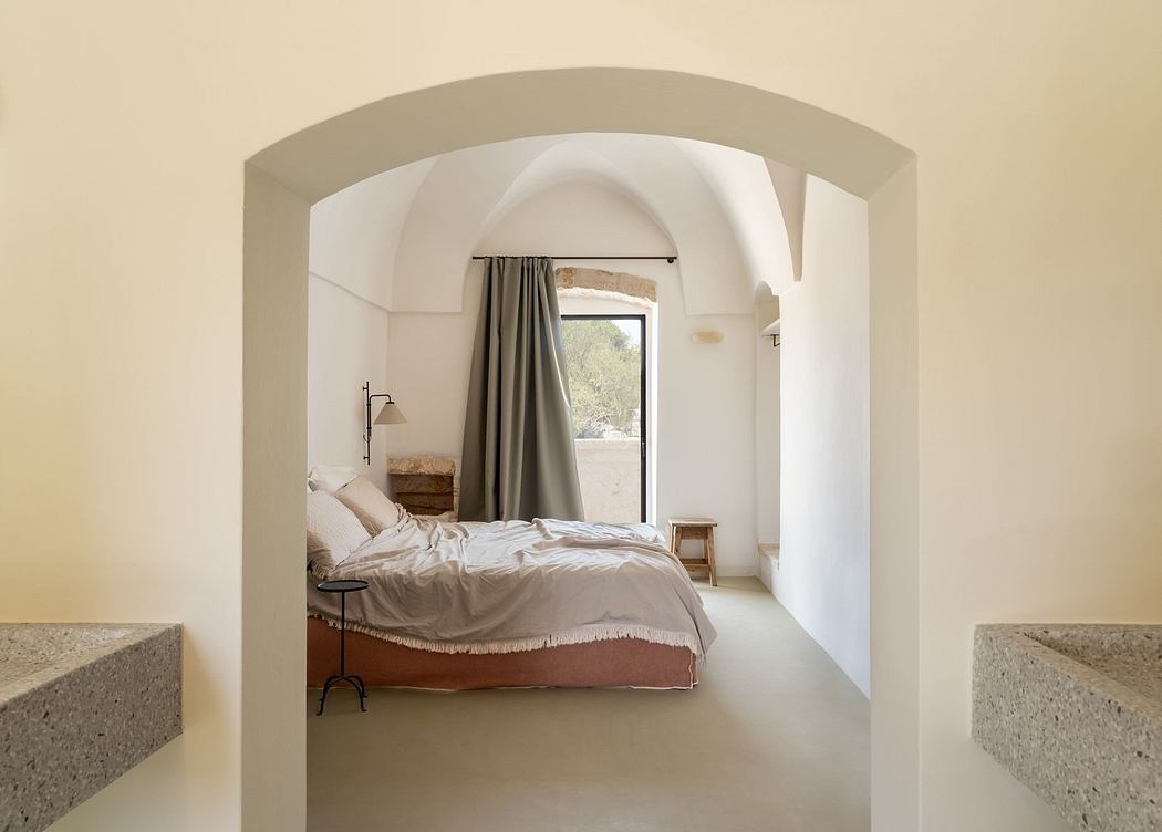 Minimalist bedroom with arched doorway and neutral tones.