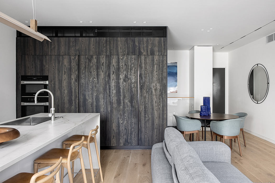 Modern kitchen with wood accents, adjacent dining area, and minimalist decor.