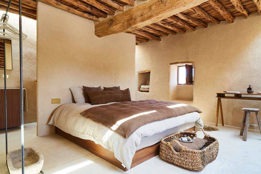 Rustic bedroom with exposed beams and neutral tones.