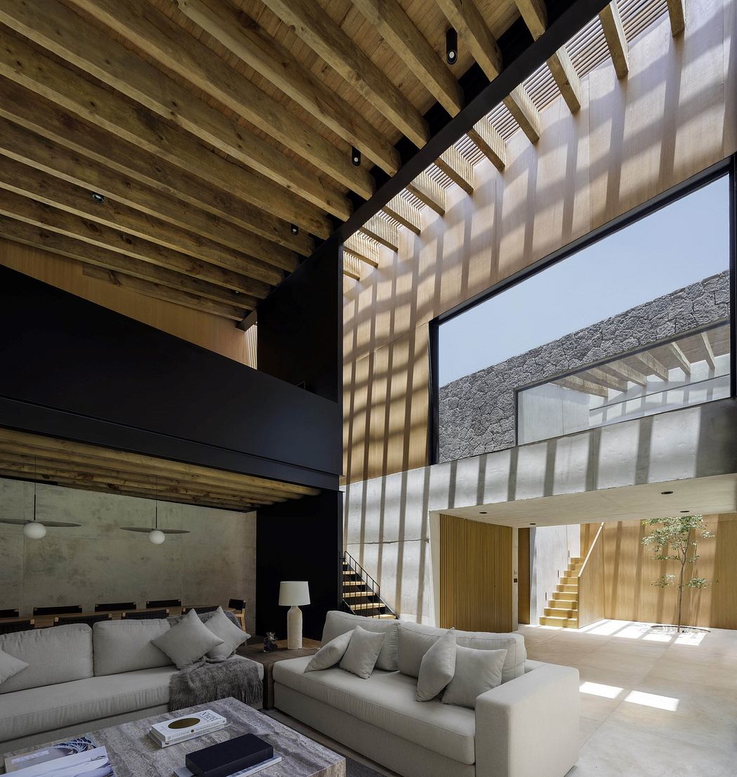 Modern interior with high ceilings, wooden beams, and large windows.