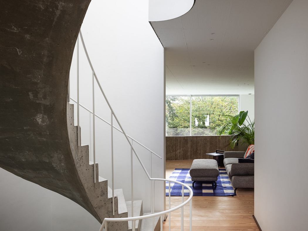 Modern interior with a spiral staircase and minimalist living space.