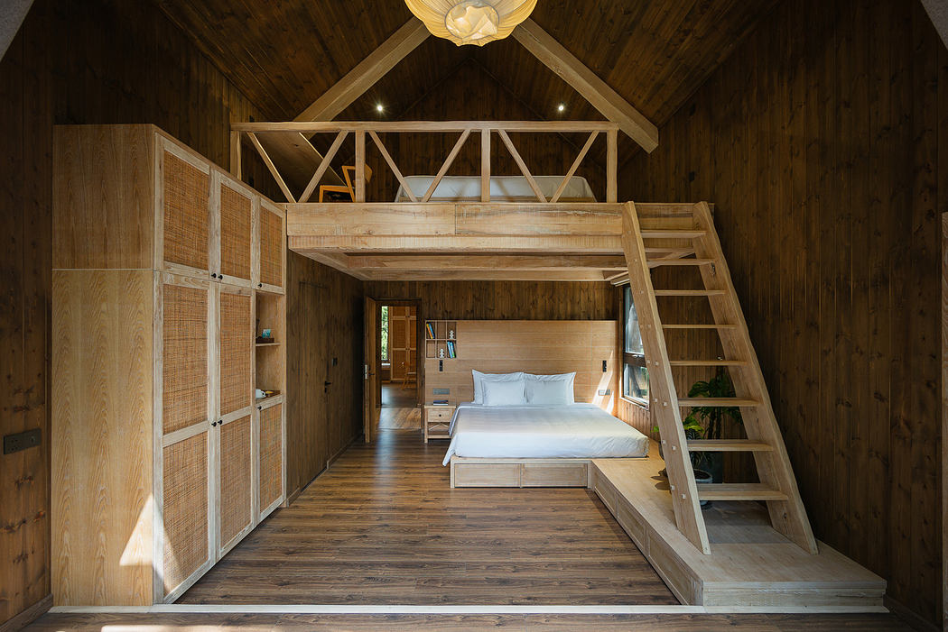 Minimalist wooden loft bedroom with high ceiling and geometric light fixture.