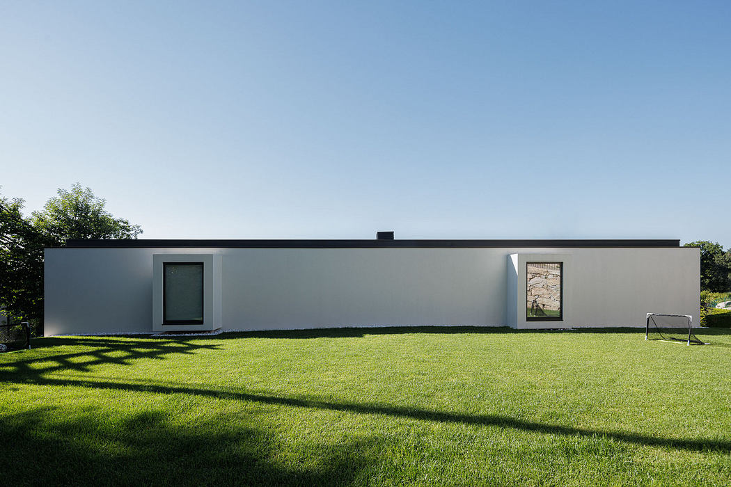 Modern single-story house with a flat roof and minimalist design.
