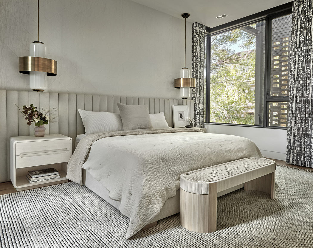 Modern bedroom with a neutral color palette, large bed, and pendant lights.