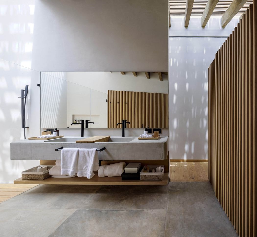 Modern bathroom with wooden slats and concrete sink.