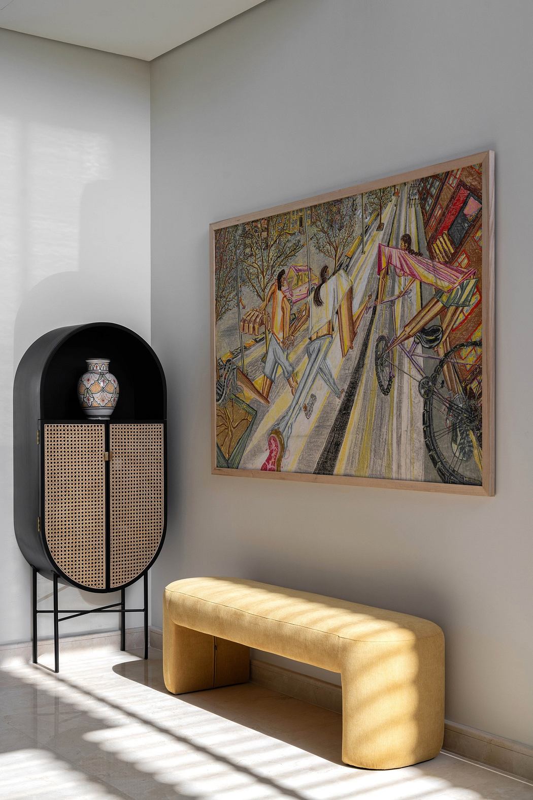 Minimalist interior with an abstract painting, a curved bench, and an arched