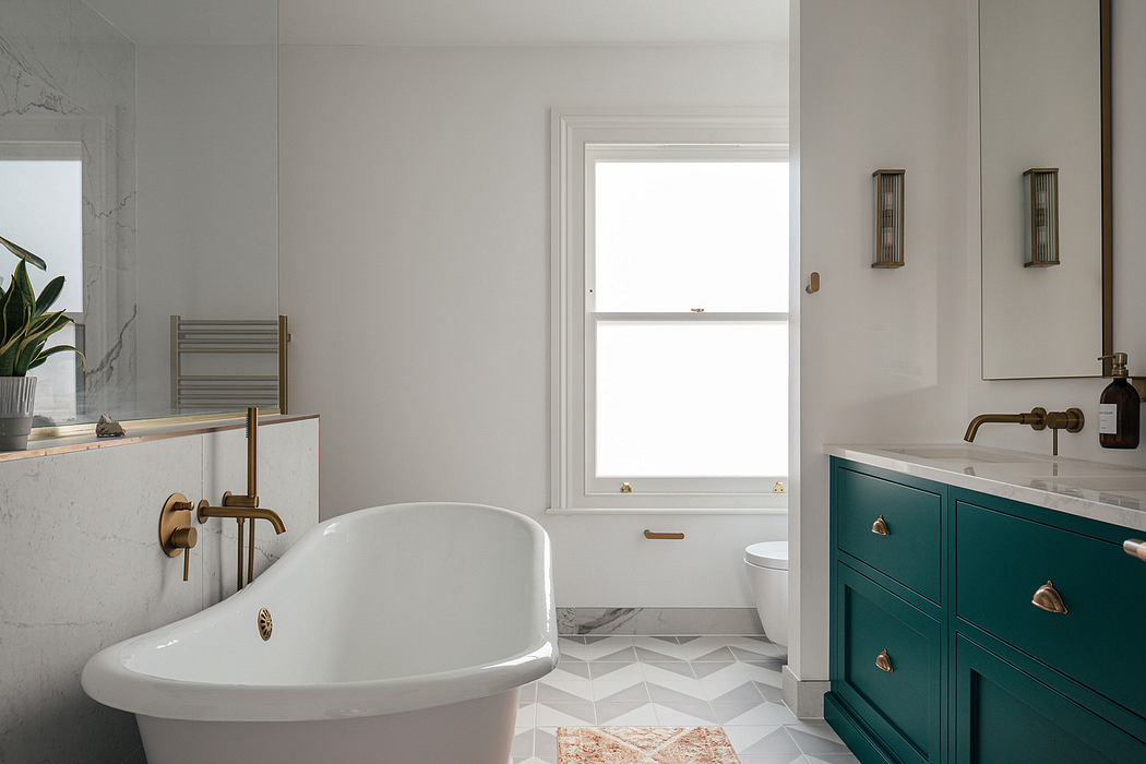 Modern bathroom with a freestanding tub and teal vanity.