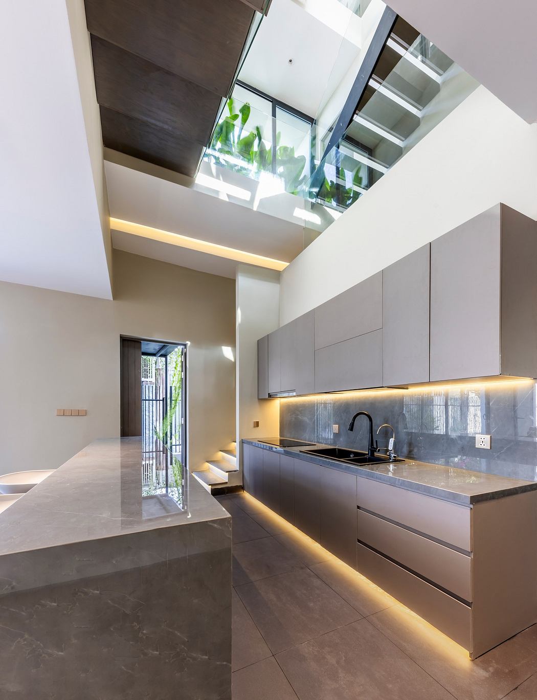 Modern kitchen interior with skylight and minimalist cabinets.