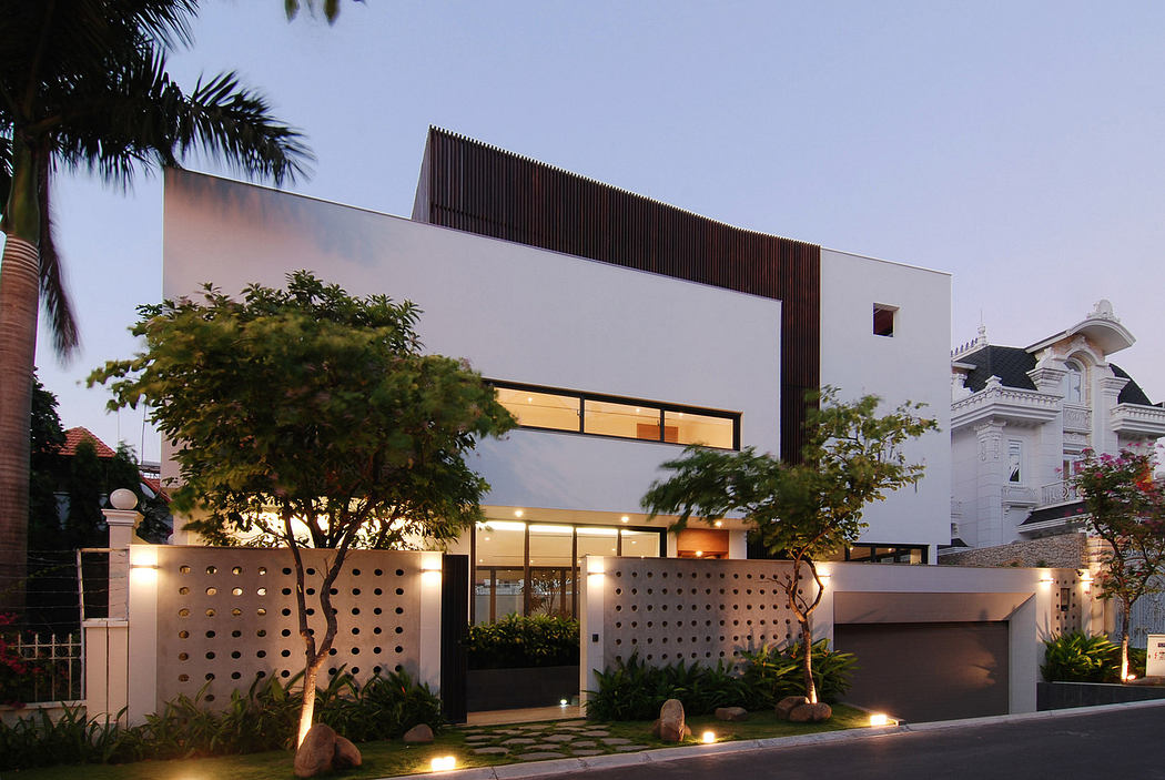 Modern two-story house with illuminated windows at twilight.