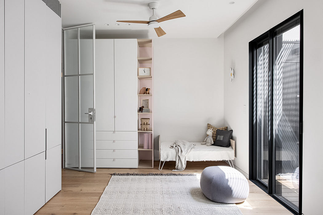 Modern minimalist bedroom with white walls, wooden floor, and large window.