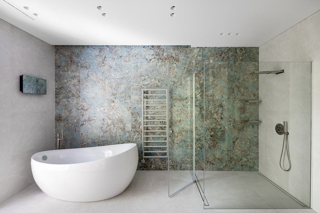 Modern bathroom with a freestanding tub and textured blue wall.