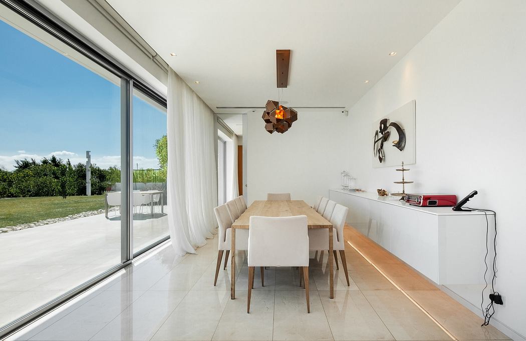 Modern dining room with table, chairs and floor-to-ceiling windows.