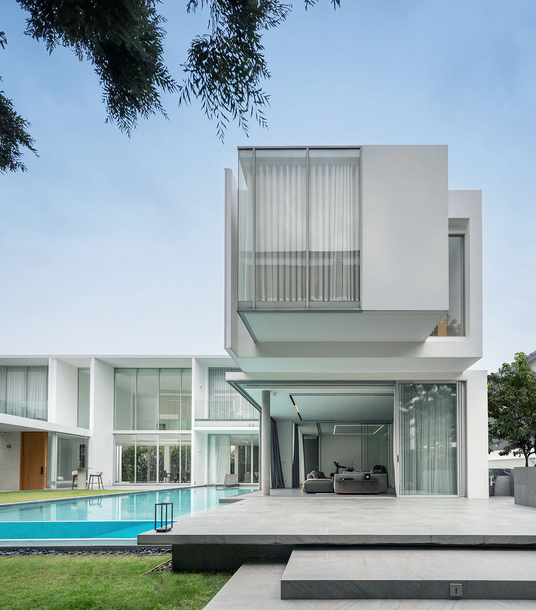 Modern house with geometric design, large windows, and a pool.