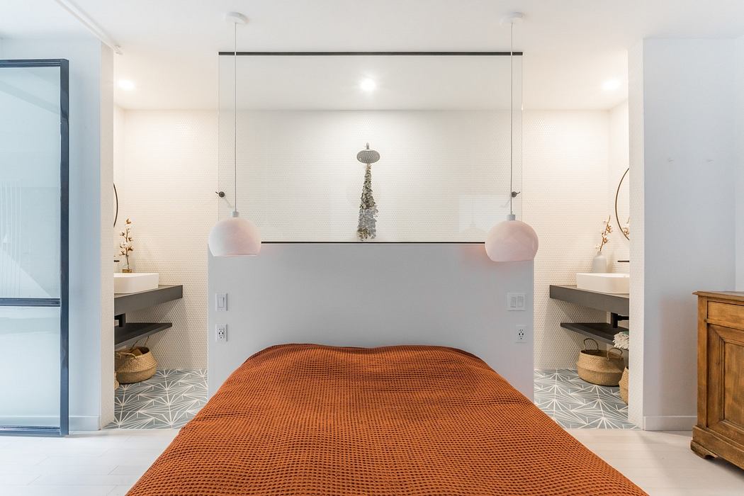Modern minimalist hallway with pendant lights and a textured orange rug.