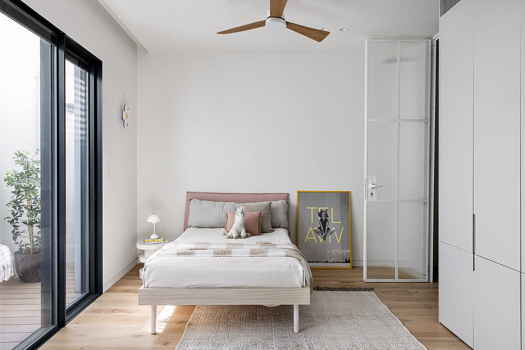 Modern minimalist bedroom with a white color scheme and natural wood accents.