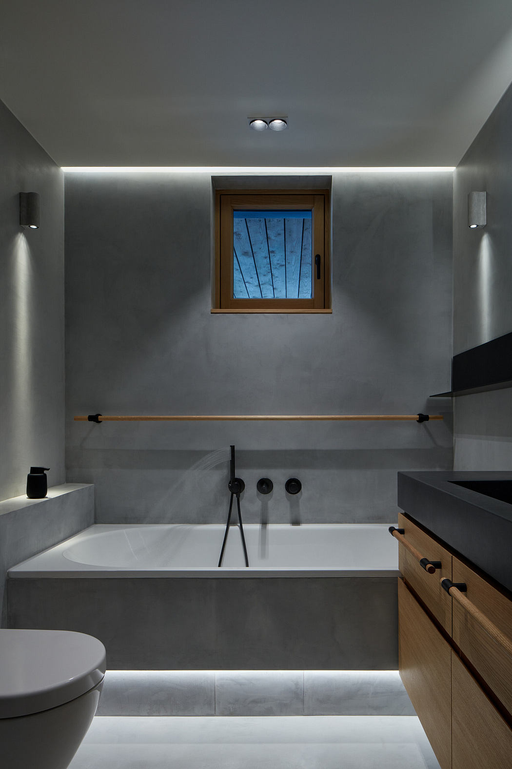 Modern bathroom with gray tones, LED lighting, and wooden accents.