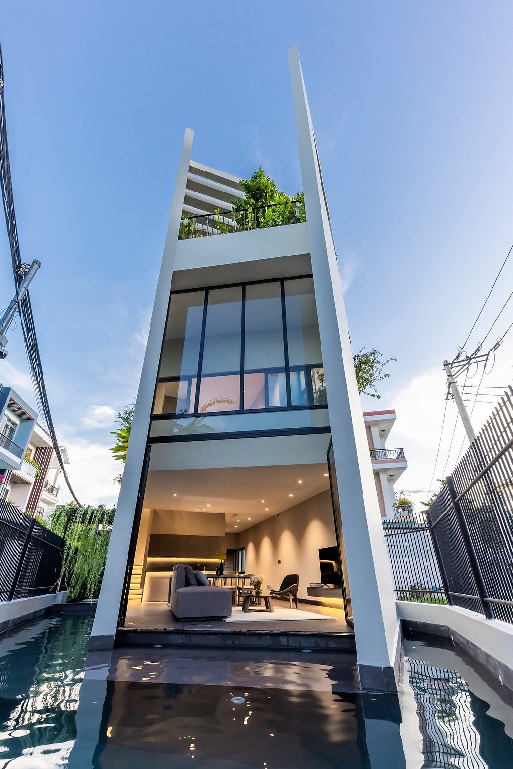 Modern multi-level home with large windows, pool, and sleek design.