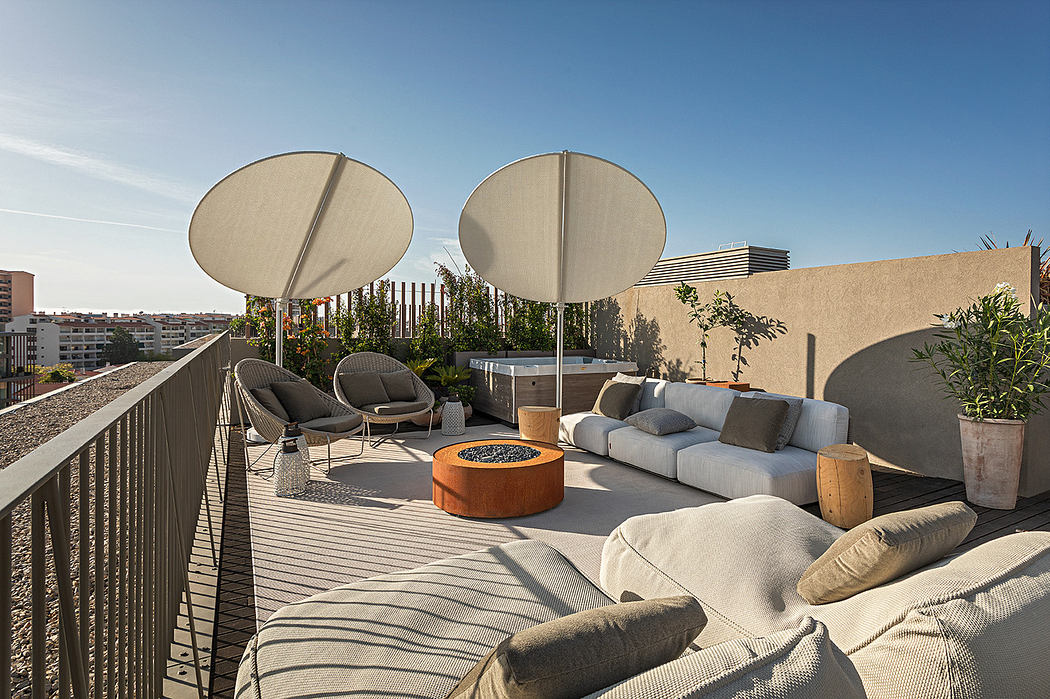 Modern rooftop terrace with seating area, umbrellas, and city view.