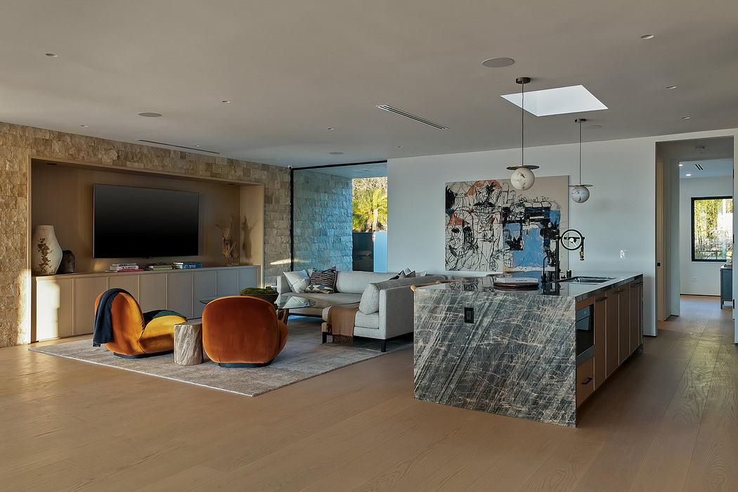 Modern living room with a kitchen island, contemporary furniture, and large windows.